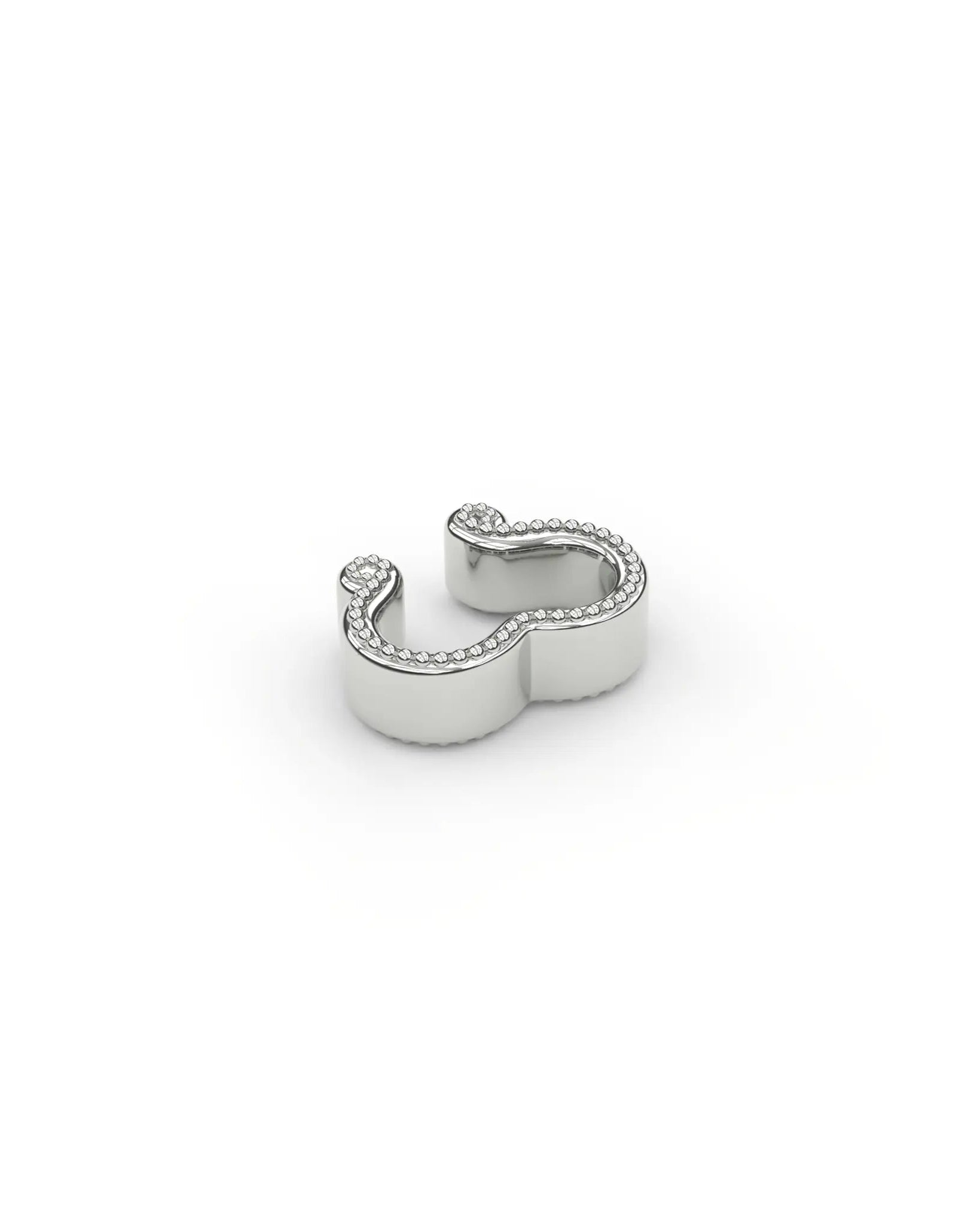 Sterling silver sculpted milgrain ear cuff, shown in an elevated perspective flat-lay view. Showcasing the fine milgrain detail tracing the contours of the design.