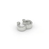 Sterling silver sculpted milgrain ear cuff, shown in an elevated perspective flat-lay view. Showcasing the fine milgrain detail tracing the contours of the design.